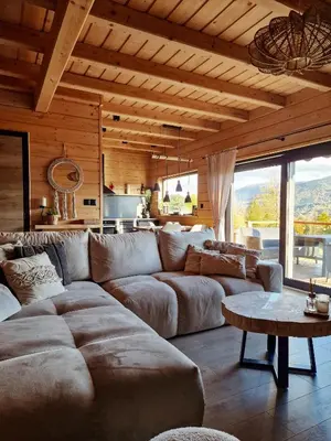 a living room with a large couch and a table at Domek Jaworówka in Zawoja