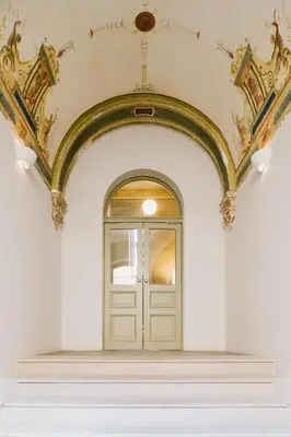 an archway leading to a door in a building at Urban Hideaway in Kraków