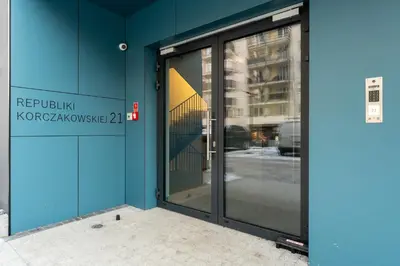 an entrance to a building with glass doors at Prokocim Superior Apartment by BookingHost in Kraków