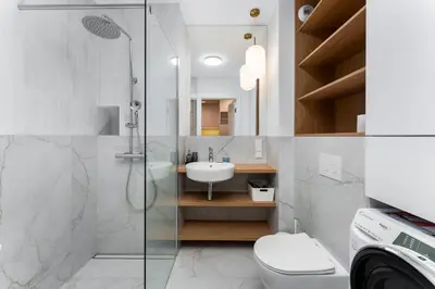 a bathroom with a shower and a toilet and a sink at Prokocim Superior Apartment by BookingHost in Kraków