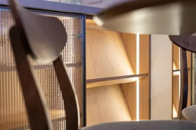 a room with a chair and a book shelf at Prokocim Superior Apartment by BookingHost in Kraków