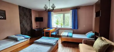 a living room with two beds and a window at Kwatery prywatne Noclegi pracownicze in Wola Batorska