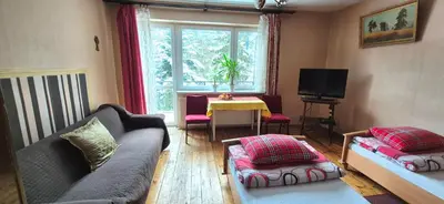 a living room with a couch and a table at Kwatery prywatne Noclegi pracownicze in Wola Batorska
