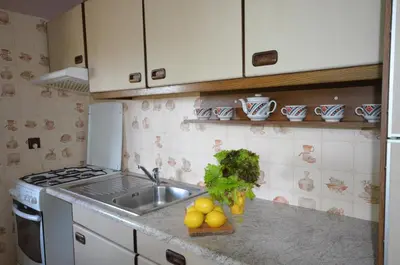a kitchen with a sink and fruits and vegetables on the counter at Kwatery prywatne Noclegi pracownicze in Wola Batorska