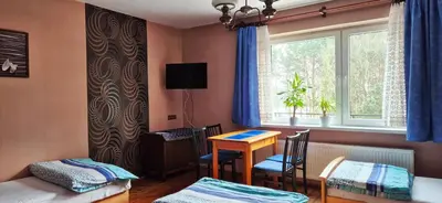 a room with a desk and a bed and a window at Kwatery prywatne Noclegi pracownicze in Wola Batorska