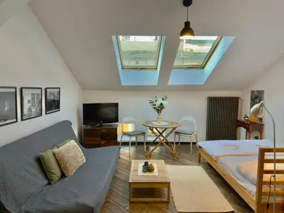 a living room with a couch and a table at Stylish 1BR for 4 in Old Town - Main Square in Kraków