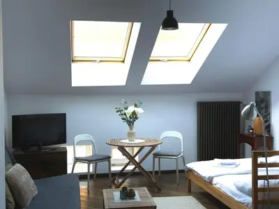 a living room with a table and a tv at Stylish 1BR for 4 in Old Town - Main Square in Kraków