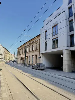 a car parked on a street next to a building at Stylish 1BR for 4 in Old Town - Main Square in Kraków