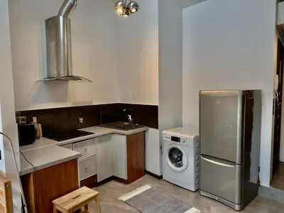 a kitchen with a refrigerator and a washing machine at Stylish 1BR for 4 in Old Town - Main Square in Kraków