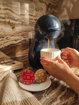 a coffee maker sitting on a counter with coffee beans at Kings City Szlak 77 55sqm Round Bed 230cm Two Balconies in Kraków