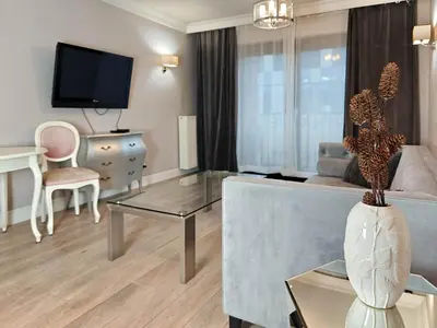 a living room with a couch and a table at Kings City Szlak 77 55sqm Round Bed 230cm Two Balconies in Kraków