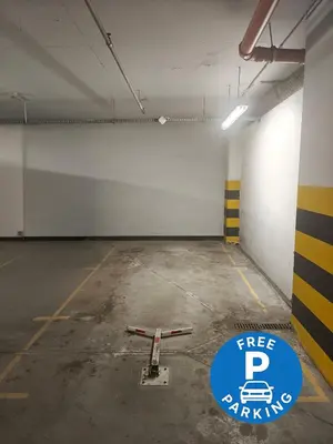 a parking garage with a free parking sign in it at Kings City Szlak 77 55sqm Round Bed 230cm Two Balconies in Kraków