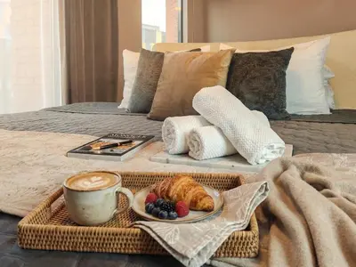 a kitchen with white cabinets and a stone wall at Kings City Szlak 77 55sqm Round Bed 230cm Two Balconies in Kraków