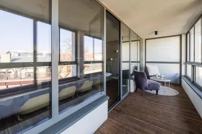 a room with windows and a chair and a table at 4 Bedroom apartment with a balcony - Trynitarska 6 in Kraków