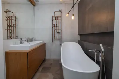 a bathroom with a white tub and a sink at 4 Bedroom apartment with a balcony - Trynitarska 6 in Kraków