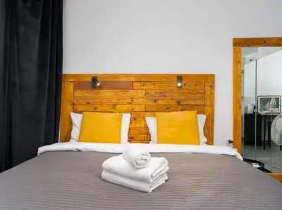 a bed with towels and a stuffed animal on top of it at Wawel Kossak Residence Loft Studio by BookingHost in Kraków