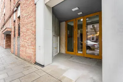 an entrance to a brick building with wooden doors at Wawel Kossak Residence Loft Studio by BookingHost in Kraków