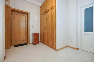 an empty room with wooden cabinets and a door at Downtown Cozy Corner in Kraków