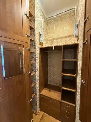 a walk in closet with wooden doors and shelves at Downtown Cozy Corner in Kraków