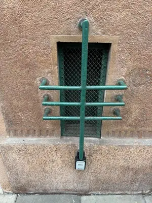 a green cross on the side of a building at Downtown Cozy Corner in Kraków