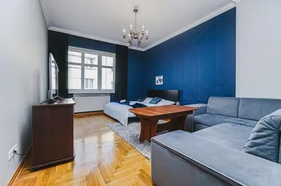 a living room with a couch and a table at Downtown Cozy Corner in Kraków
