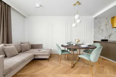 a living room with a couch and a table and chairs at Atmospheric Apartment with Ideal Location in Cracow by Noclegi Renters in Kraków