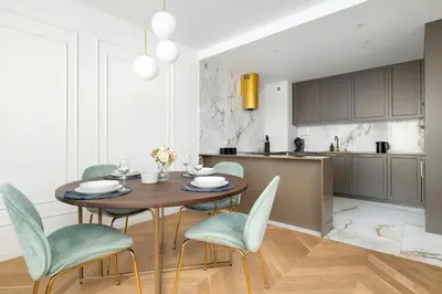 a kitchen and dining room with a wooden table and chairs at Atmospheric Apartment with Ideal Location in Cracow by Noclegi Renters in Kraków
