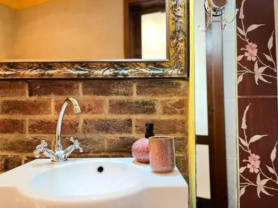 a sink in a bathroom with a mirror at Apartment for 4 guests in historic Cracow Podgórze in Kraków
