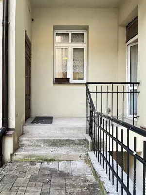 a window on the side of a building with stairs at Apartment for 4 guests in historic Cracow Podgórze in Kraków