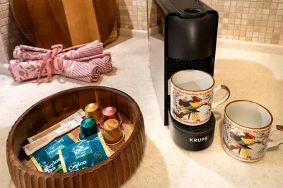 a coffee maker and two cups on a counter at Malila Premium Apartments Cracow Pułaskiego 14 in Kraków
