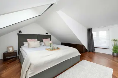 a bedroom with a large bed in a attic at Family Two-Level Apartment with Air Conditioning by Noclegi Renters in Kraków