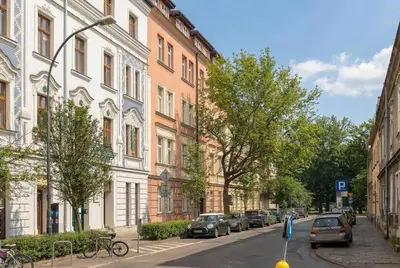 a street with cars parked on the side of the road at Family Two-Level Apartment with Air Conditioning by Noclegi Renters in Kraków