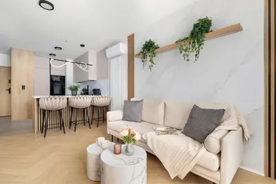 a living room with a couch and a table at Stylowy Apartament z Parkingiem & Balkonem, Blisko Wisły by Noclegi Renters in Kraków