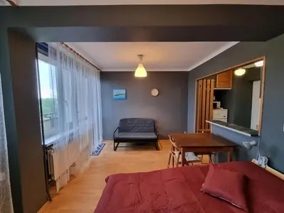 a bedroom with a bed and a desk and a table at mieszkanie z widokiem na Wawel in Kraków