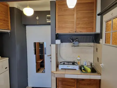 a small kitchen with a sink and a stove at mieszkanie z widokiem na Wawel in Kraków