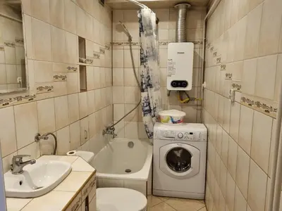 a bathroom with a sink and a washing machine at mieszkanie z widokiem na Wawel in Kraków