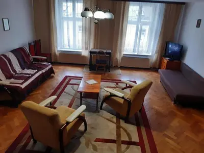 a living room with a couch and a table and chairs at Let's go back to the memories in Kraków