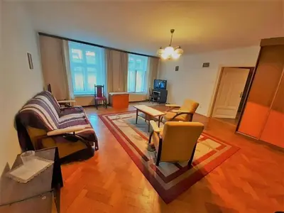 a living room with a couch and a table at Let's go back to the memories in Kraków