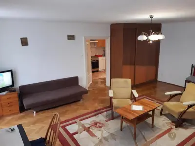 a living room with a couch and a table at Let's go back to the memories in Kraków