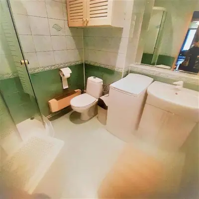 a bathroom with a toilet and a sink at Let's go back to the memories in Kraków