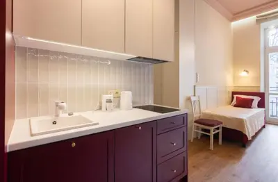 a bathroom with a sink and a bed in a room at Dodo Acomodo 10 - Kazimierz, Vintage - High Ceilings - Near Station in Kraków