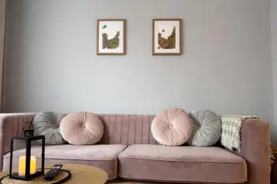 a living room with a couch with pillows on it at Apartament Paoli 2 in Zator