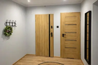 a room with a door and areath on the wall at Apartament Paoli 2 in Zator