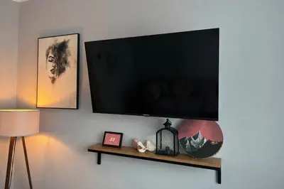 a flat screen tv hanging on a wall at Apartament Paoli 2 in Zator