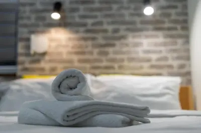 a towel sitting on top of a bed at Cracow Downtown Comfort Studio by BookingHost in Kraków