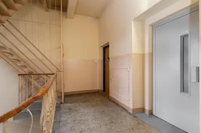 an empty room with a staircase and a door at Nowa Huta Standard Apartment by BookingHost in Kraków