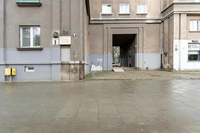 an empty parking lot in front of a building at Nowa Huta Standard Apartment by BookingHost in Kraków