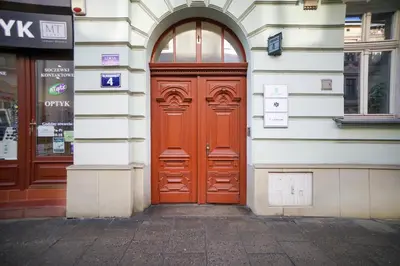 a red door on the side of a building at Ultracentral Downtown Sky in Kraków