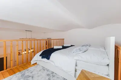 a kitchen with white cabinets and a white door at Ultracentral Downtown Sky in Kraków