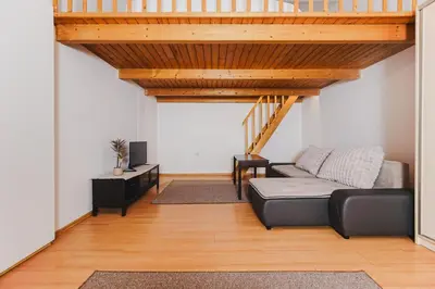 a living room with a couch and a table at Ultracentral Downtown Sky in Kraków